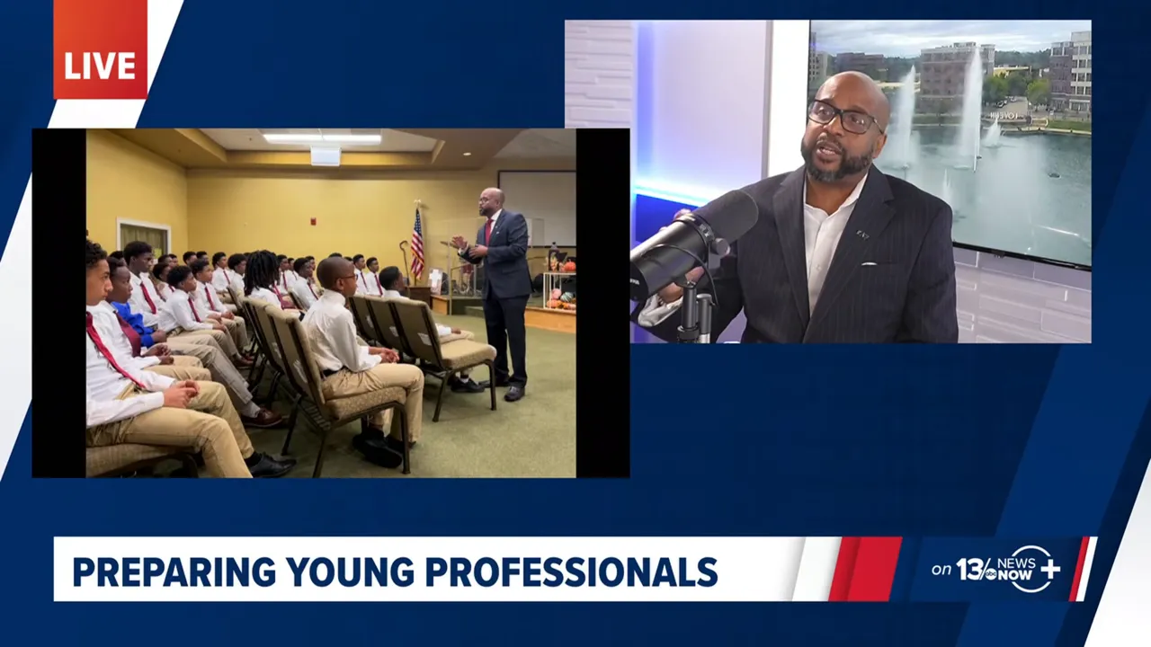 Split screen on 13News Now: Dr. Kester Crosse at the studio microphone, beside a photo of him speaking to a room of young men in white shirts and ties, under the caption Preparing Young Professionals